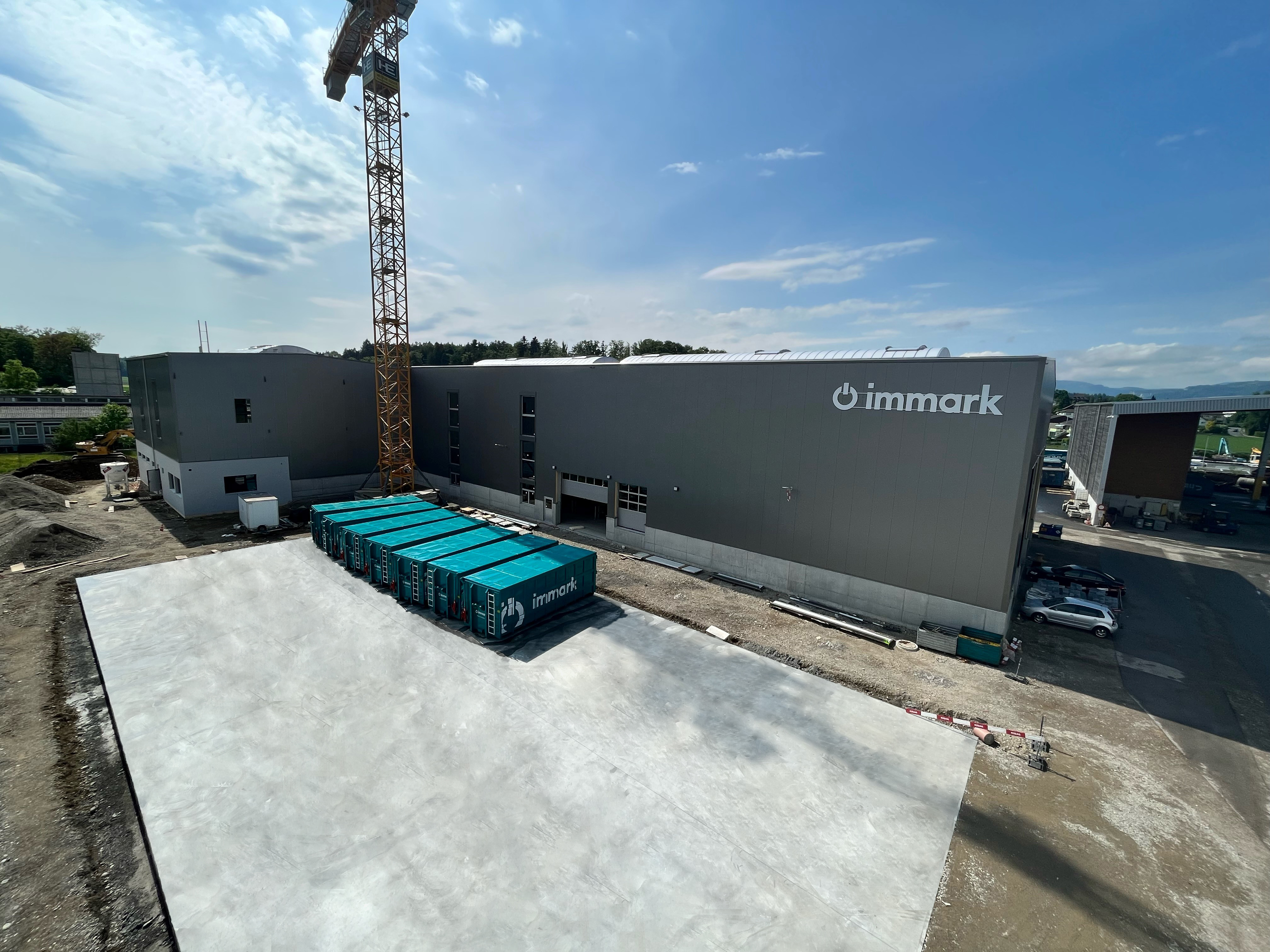 Die neue Verarbeitungshalle von Immark mit Containern vor der Halle